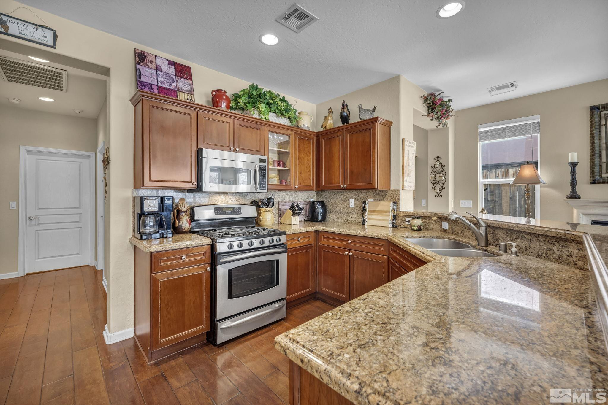 1925 Trail Creek Way Reno, NV 89523 - Photo 11 of 39 a kitchen with kitchen island granite countertop a sink cabinets and stainless steel appliances