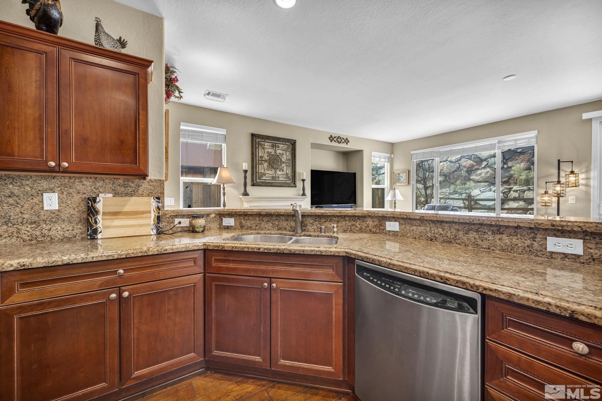 1925 Trail Creek Way Reno, NV 89523 - Photo 13 of 39 a kitchen with stainless steel appliances granite countertop a sink stove and cabinets