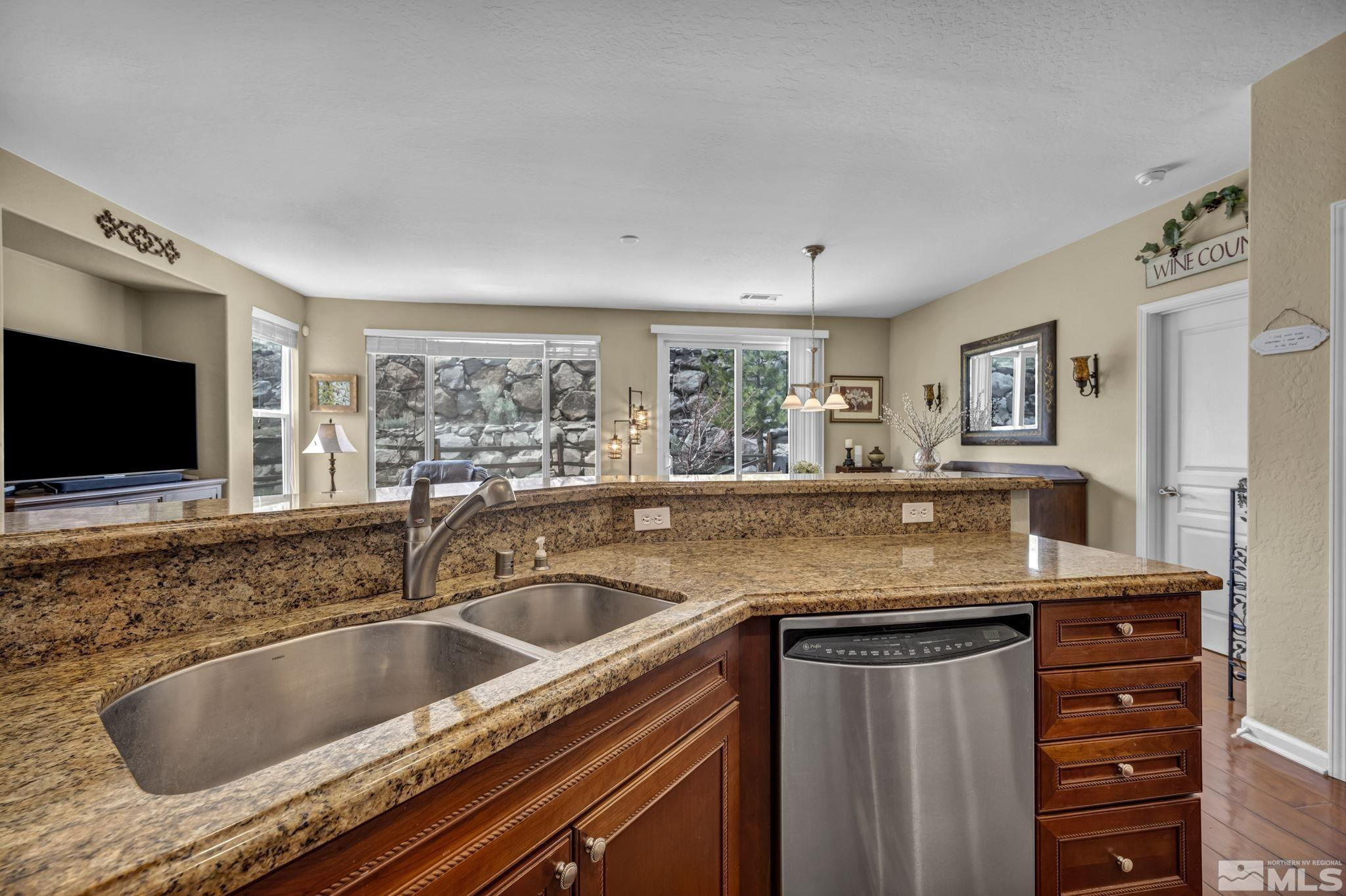 1925 Trail Creek Way Reno, NV 89523 - Photo 16 of 39 a kitchen with granite countertop a sink and a microwave