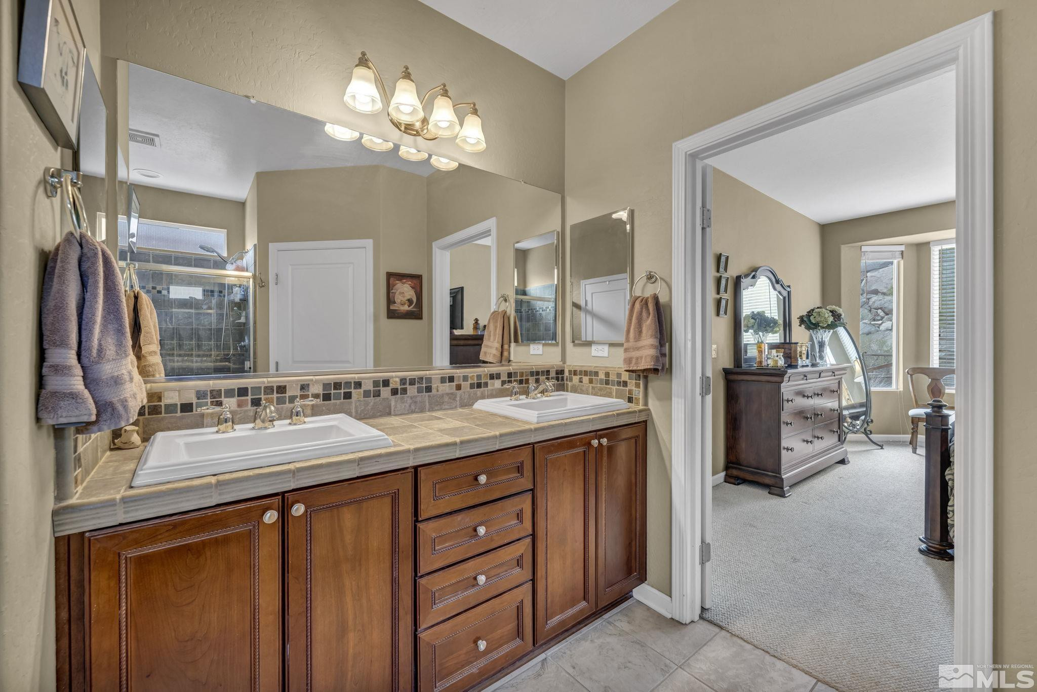 1925 Trail Creek Way Reno, NV 89523 - Photo 30 of 39 a bathroom with a double vanity sink and a mirror