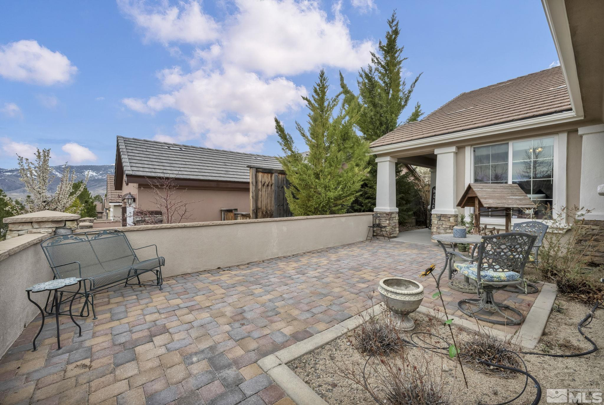 1925 Trail Creek Way Reno, NV 89523 - Photo 3 of 39 a view of a patio with table and chairs with wooden fence
