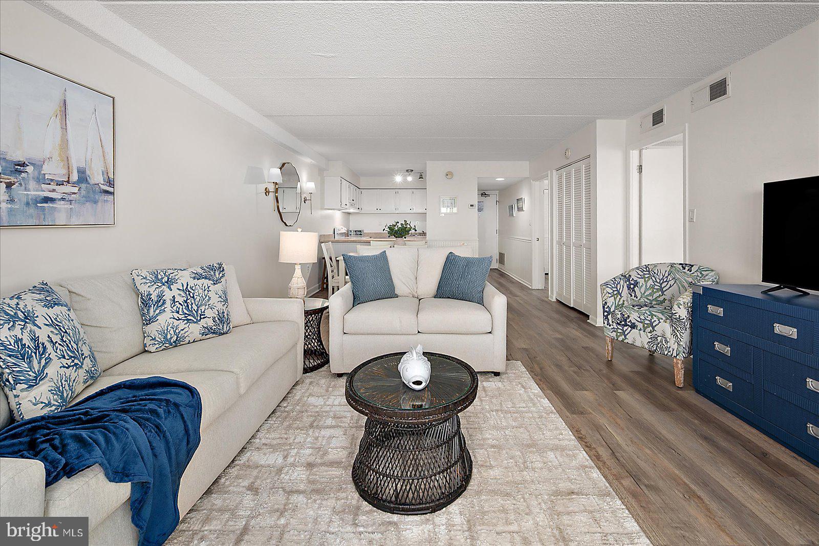 10300 Coastal Highway, Unit 1808 Ocean City, MD 21842 - Photo 47 of 47 a living room with furniture and a flat screen tv