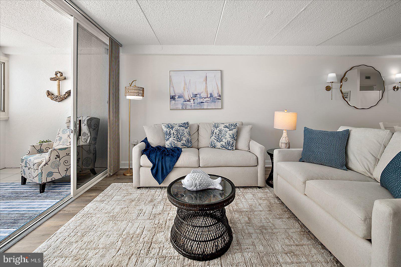10300 Coastal Highway, Unit 1808 Ocean City, MD 21842 - Photo 10 of 47 a living room with furniture a clock and a rug