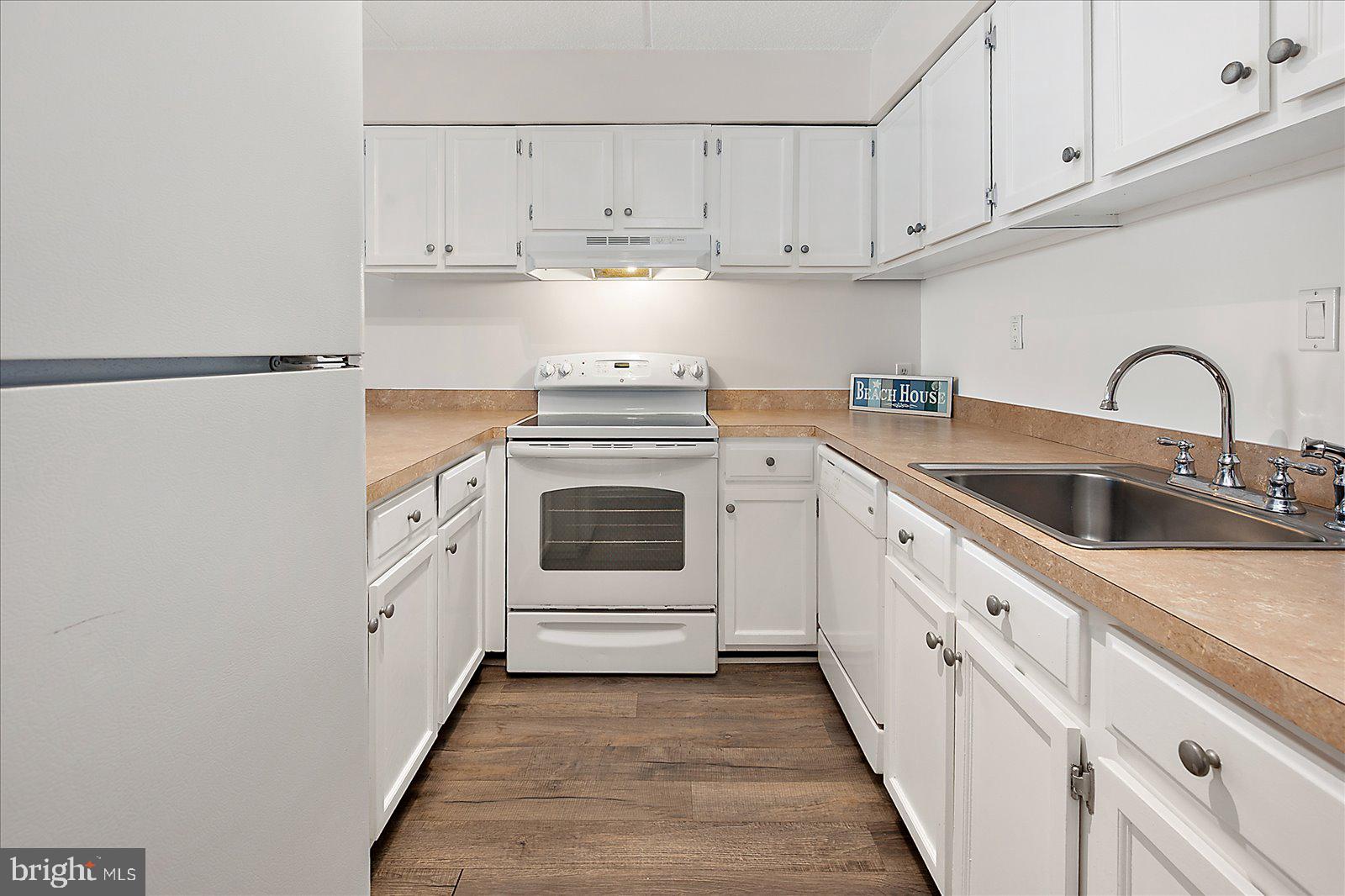 10300 Coastal Highway, Unit 1808 Ocean City, MD 21842 - Photo 13 of 47 a kitchen with cabinets appliances a sink and a stove