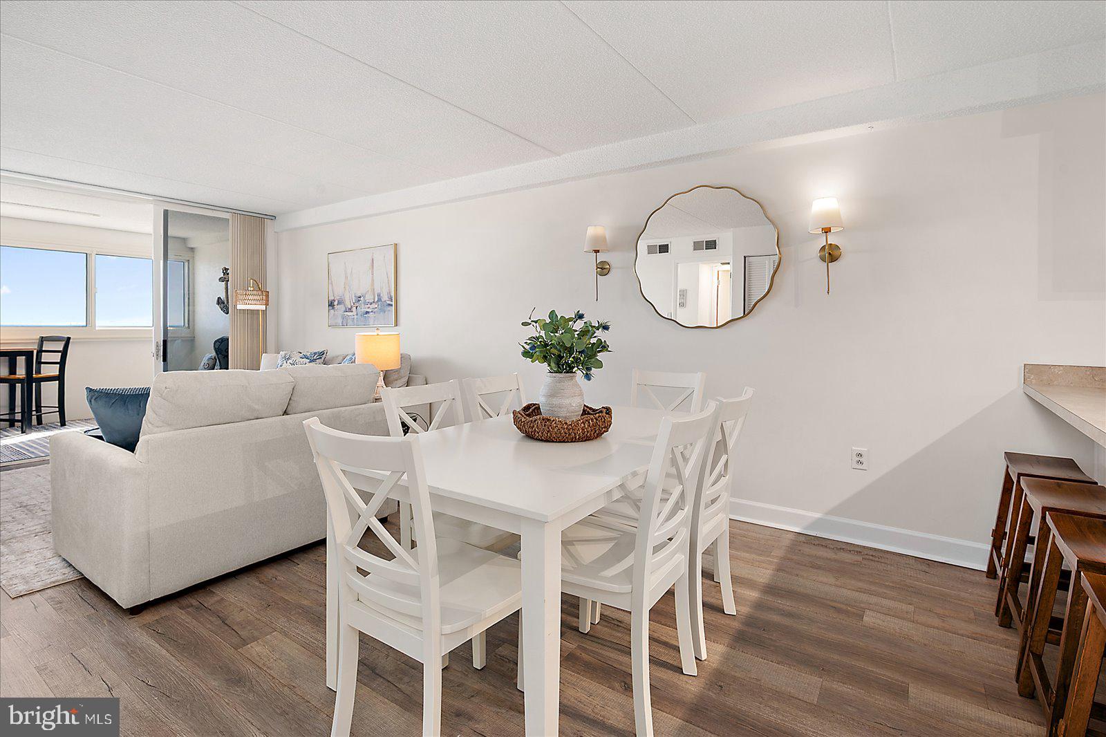 10300 Coastal Highway, Unit 1808 Ocean City, MD 21842 - Photo 17 of 47 a view of a dining room with furniture and wooden floor