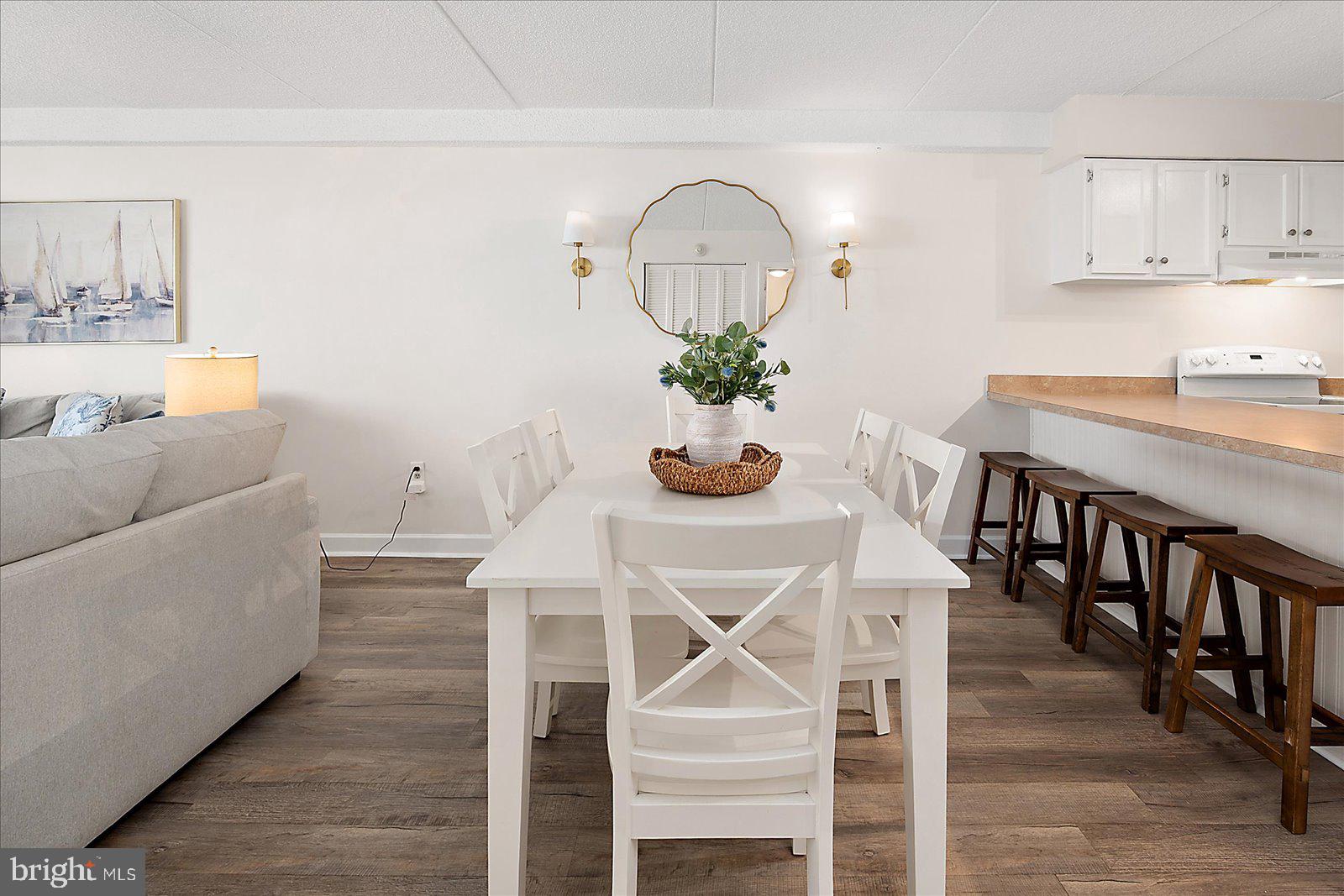 10300 Coastal Highway, Unit 1808 Ocean City, MD 21842 - Photo 18 of 47 a dining room with furniture and wooden floor
