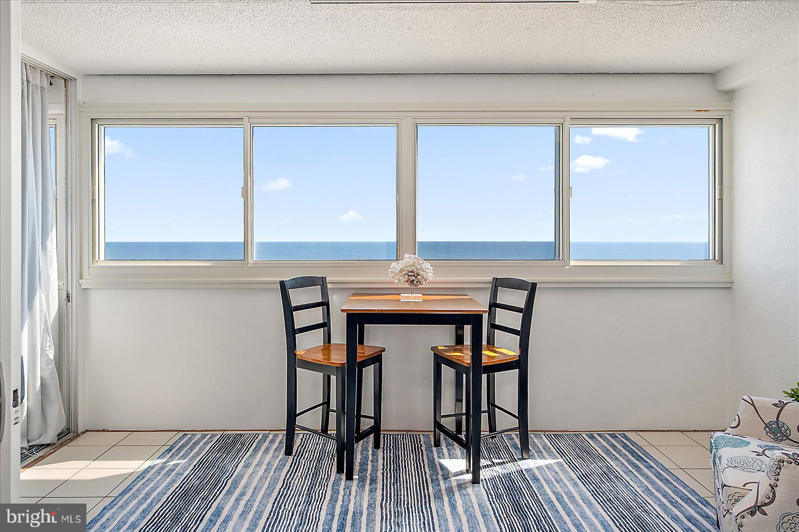 10300 Coastal Highway, Unit 1808 Ocean City, MD 21842 - Photo 2 of 47 a view of a dining room with furniture and wooden floor