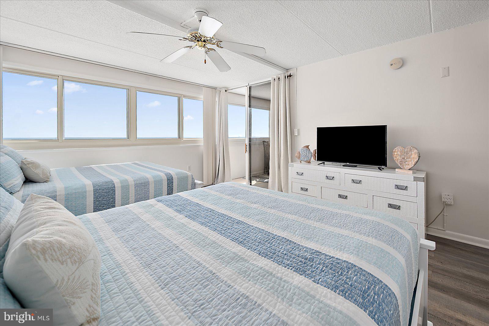 10300 Coastal Highway, Unit 1808 Ocean City, MD 21842 - Photo 20 of 47 a bedroom with a bed tv and a window