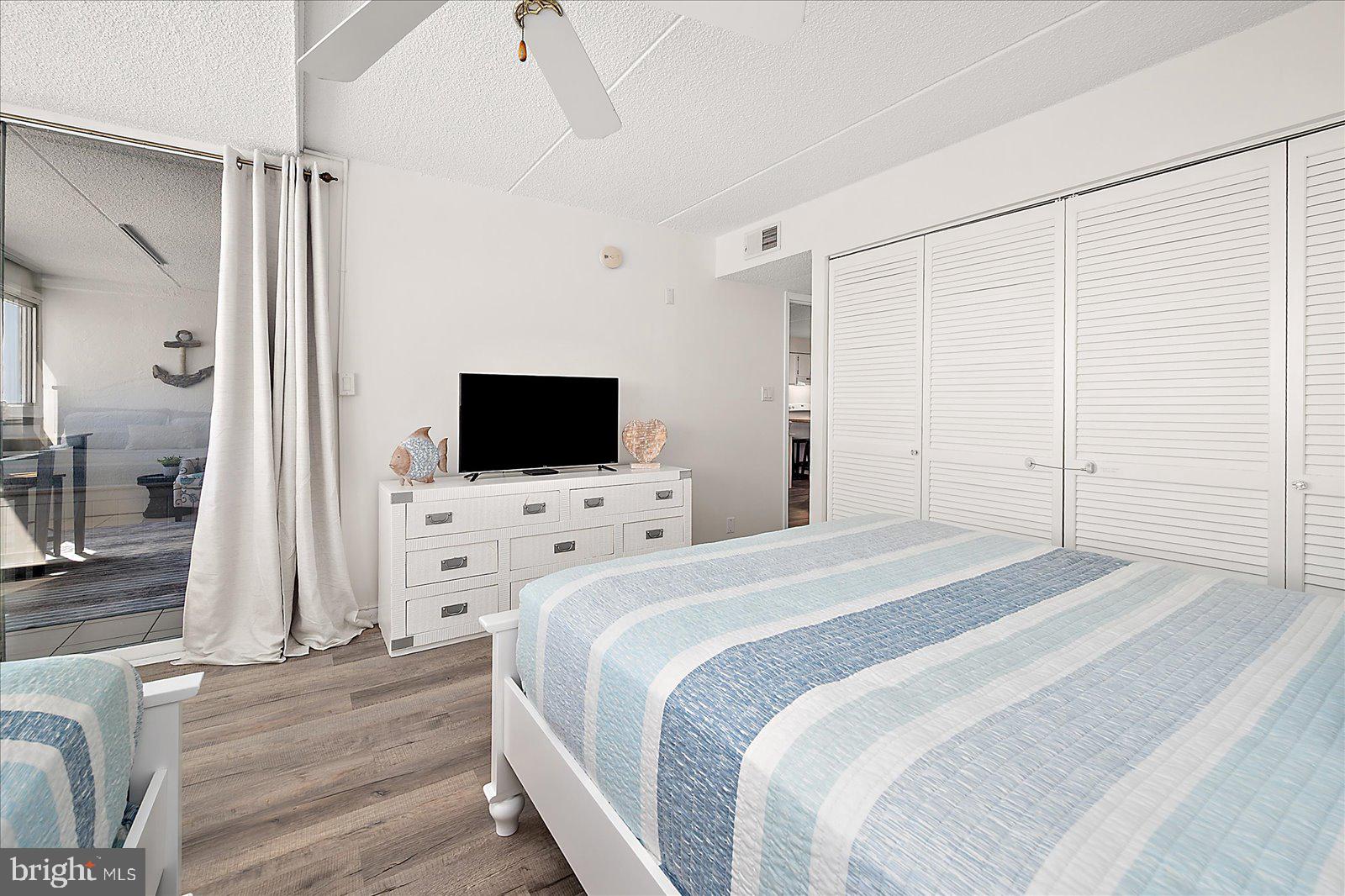 10300 Coastal Highway, Unit 1808 Ocean City, MD 21842 - Photo 23 of 47 a bedroom with a bed and a flat screen tv