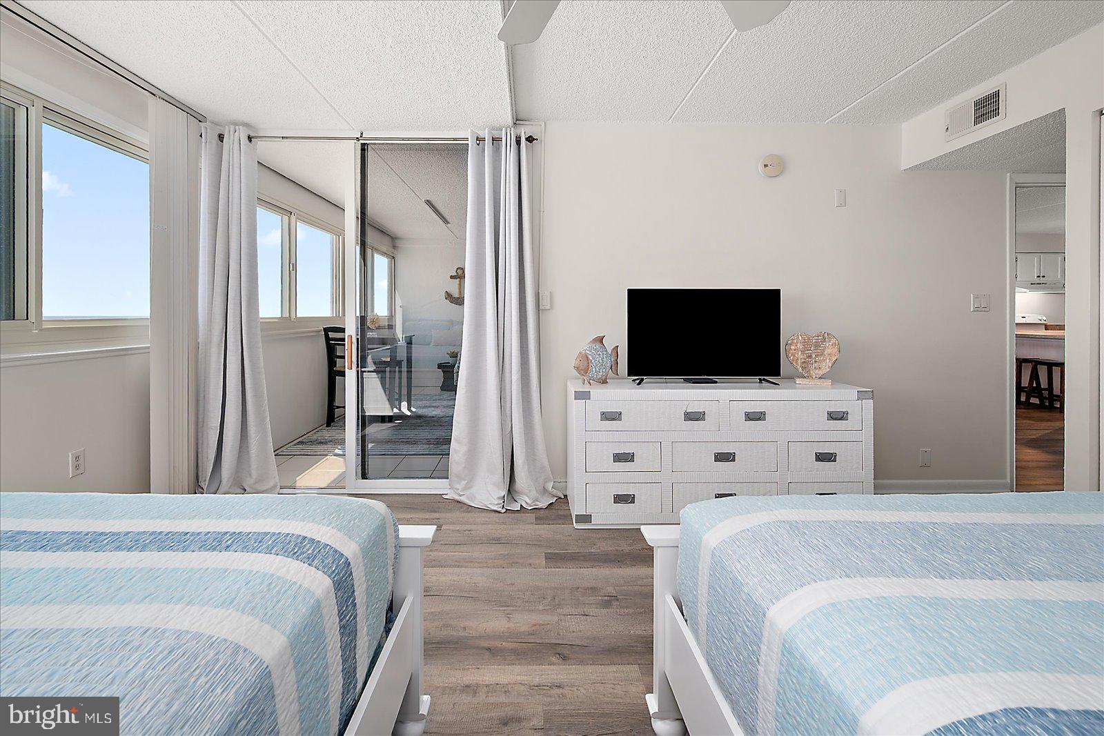 10300 Coastal Highway, Unit 1808 Ocean City, MD 21842 - Photo 26 of 47 a bedroom with a flat screen television and a bed