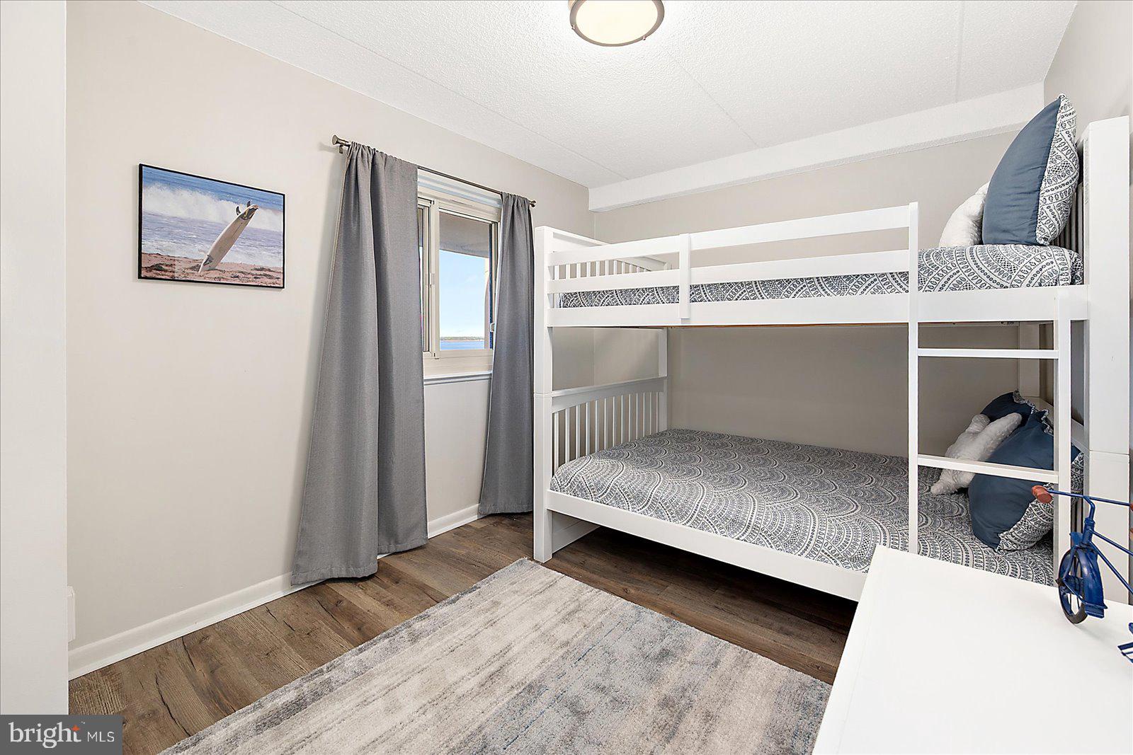 10300 Coastal Highway, Unit 1808 Ocean City, MD 21842 - Photo 28 of 47 a bedroom with a bed and a window