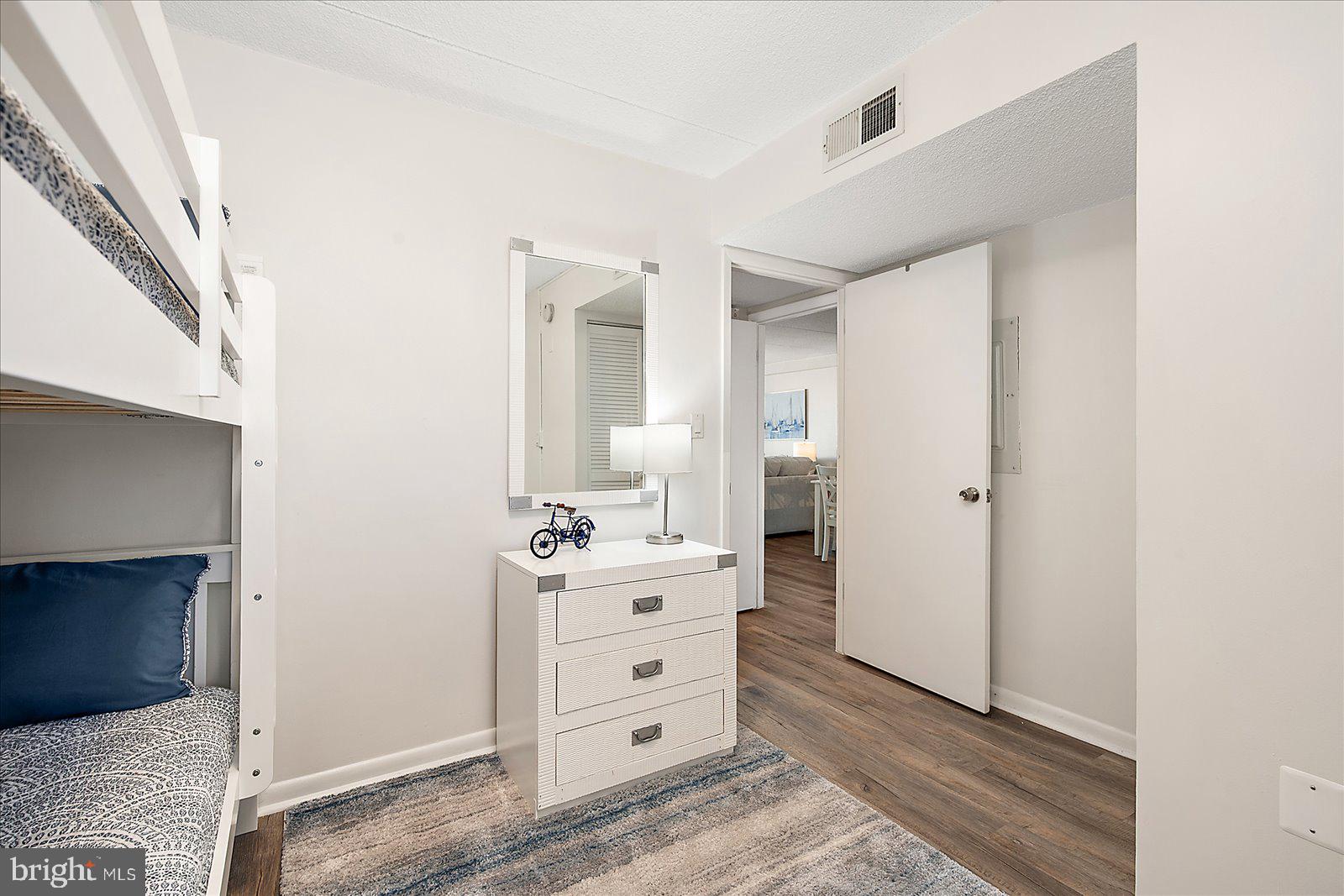 10300 Coastal Highway, Unit 1808 Ocean City, MD 21842 - Photo 31 of 47 a room with a dresser and a mirror