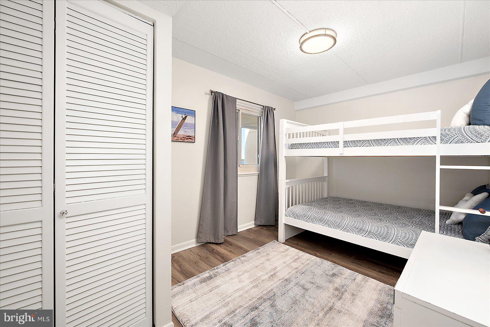 10300 Coastal Highway, Unit 1808 Ocean City, MD 21842 - Photo 32 of 47 a bedroom with a bed and a window