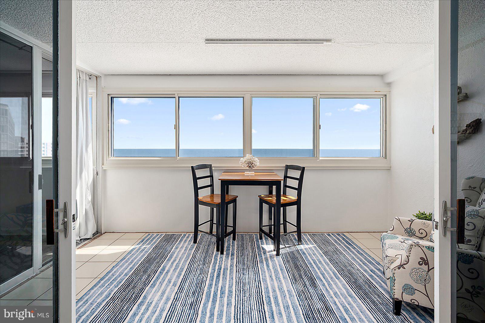 10300 Coastal Highway, Unit 1808 Ocean City, MD 21842 - Photo 35 of 47 a view of a dining room with furniture and wooden floor