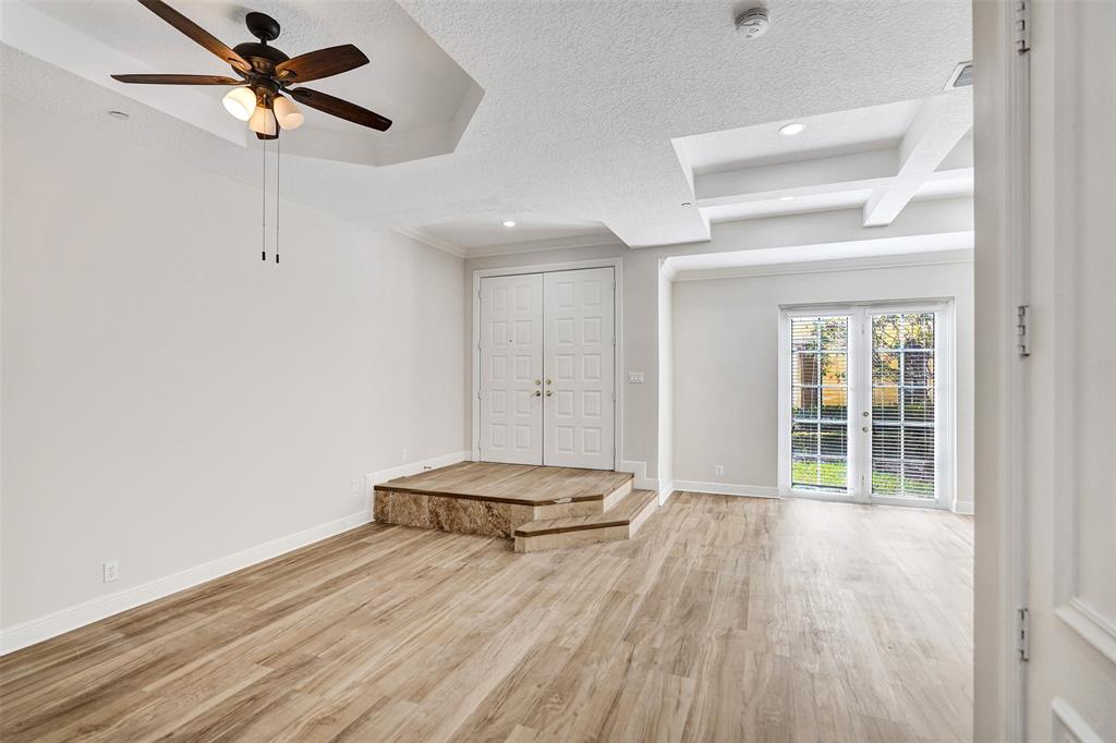 230 Northeast 69th Circle, Unit 230 Boca Raton, FL 33487 - Photo 19 of 91 a view of a room with wooden floor and a ceiling fan