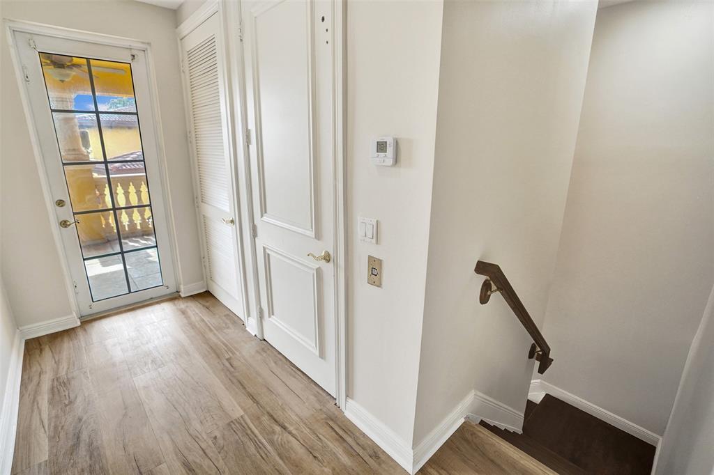 230 Northeast 69th Circle, Unit 230 Boca Raton, FL 33487 - Photo 25 of 91 a view of a hallway with wooden floor and entryway