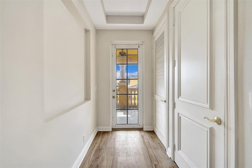230 Northeast 69th Circle, Unit 230 Boca Raton, FL 33487 - Photo 26 of 91 a view of a hallway with wooden floor and a window