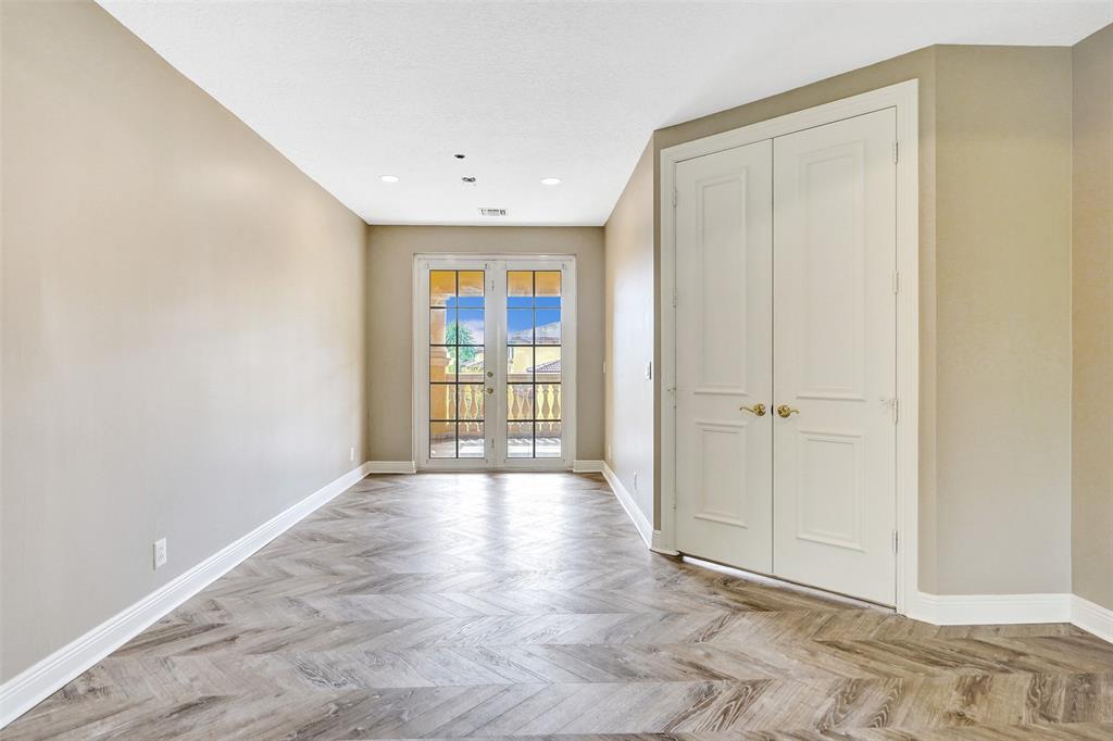 230 Northeast 69th Circle, Unit 230 Boca Raton, FL 33487 - Photo 27 of 91 a view of an empty room with wooden floor and a window