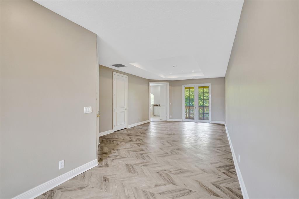 230 Northeast 69th Circle, Unit 230 Boca Raton, FL 33487 - Photo 30 of 91 a view of an empty room with wooden floor and a window