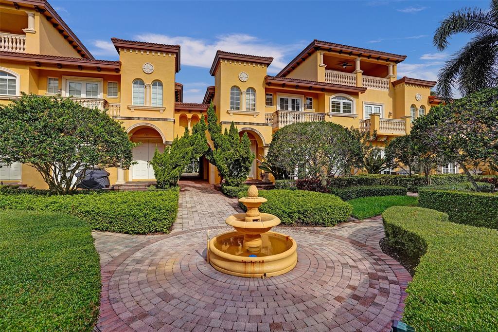230 Northeast 69th Circle, Unit 230 Boca Raton, FL 33487 - Photo 3 of 91 a front view of a house with a yard