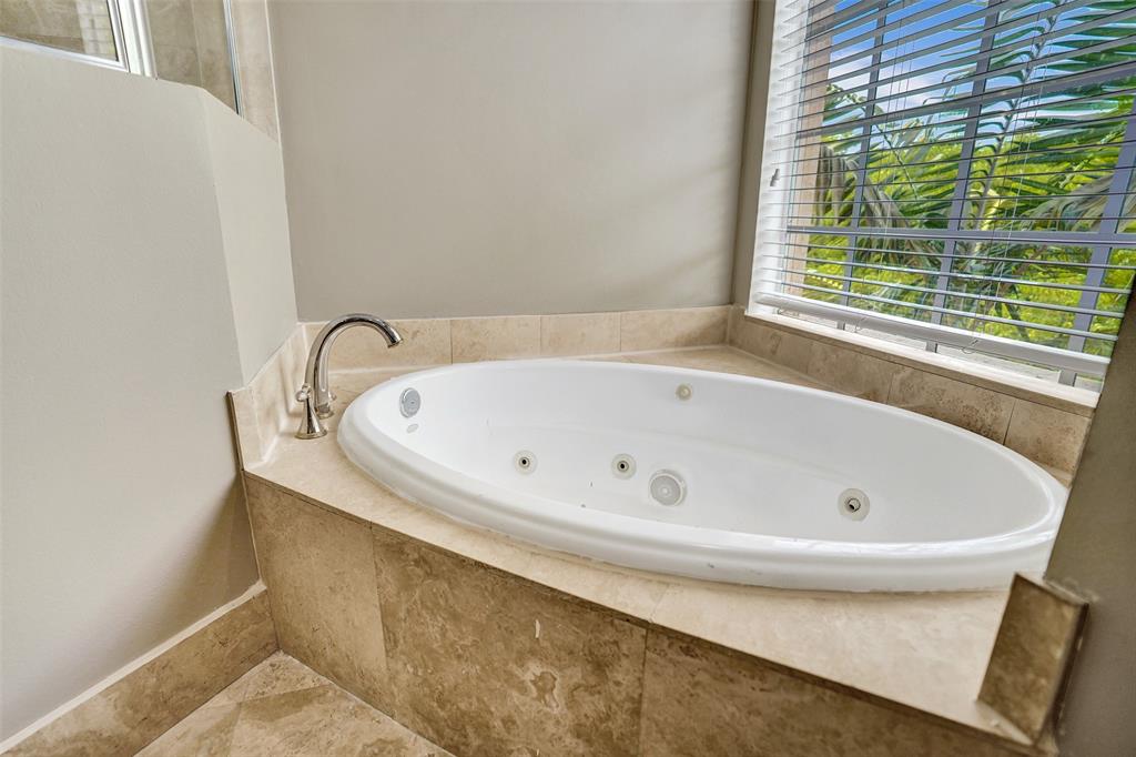 230 Northeast 69th Circle, Unit 230 Boca Raton, FL 33487 - Photo 35 of 91 a bath tub sitting in a bathroom next to a window