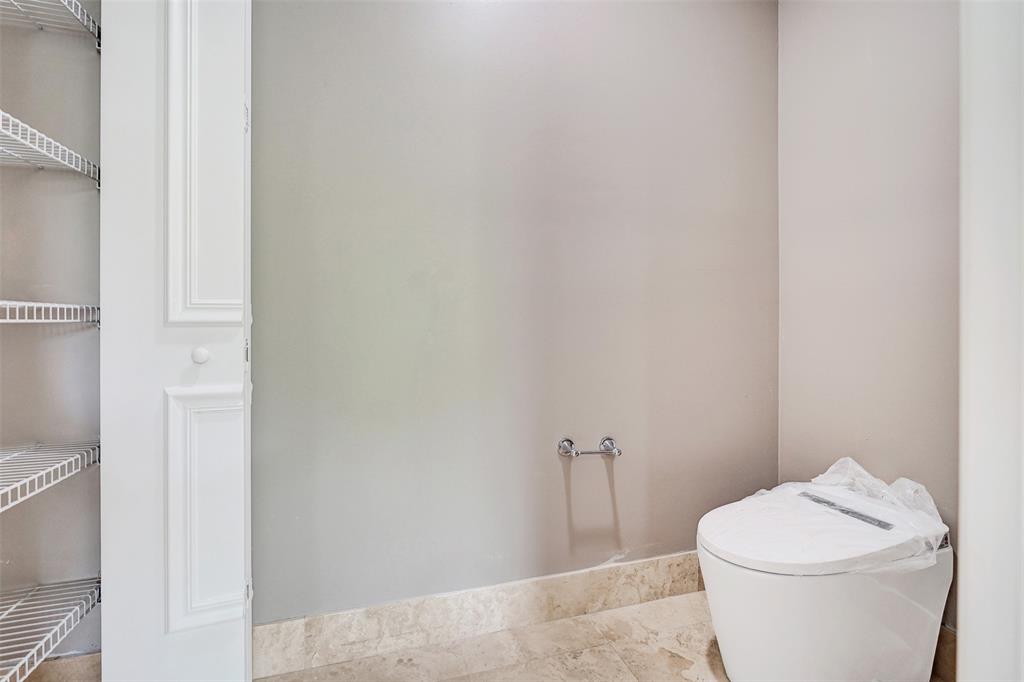 230 Northeast 69th Circle, Unit 230 Boca Raton, FL 33487 - Photo 39 of 91 a white toilet sitting next to a bathroom sink