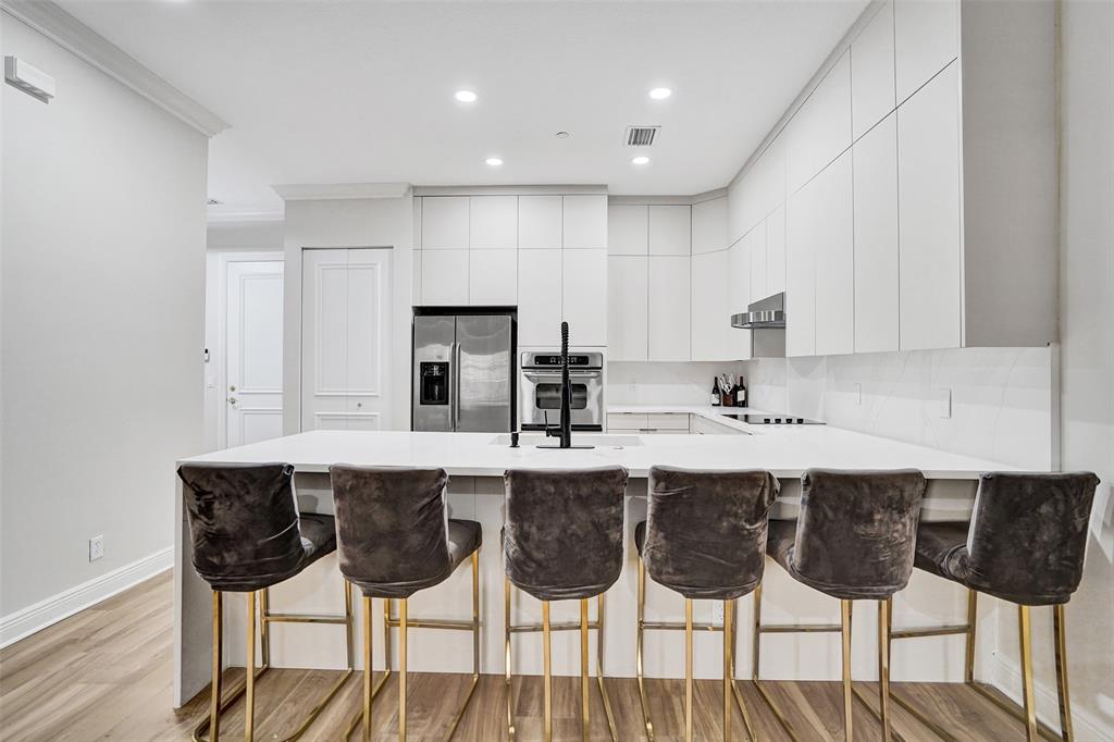 230 Northeast 69th Circle, Unit 230 Boca Raton, FL 33487 - Photo 4 of 91 a kitchen with a dining table chairs sink and cabinets