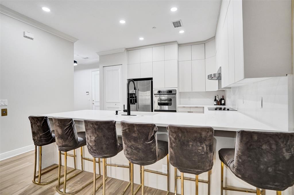 230 Northeast 69th Circle, Unit 230 Boca Raton, FL 33487 - Photo 5 of 91 a kitchen with stainless steel appliances granite countertop a sink and a refrigerator