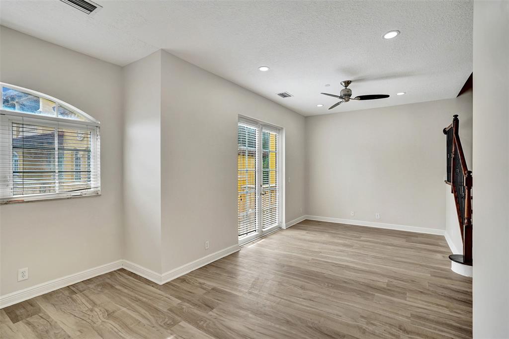 230 Northeast 69th Circle, Unit 230 Boca Raton, FL 33487 - Photo 54 of 91 a view of an empty room with wooden floor and a window