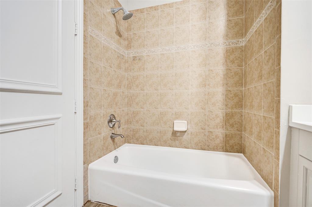 230 Northeast 69th Circle, Unit 230 Boca Raton, FL 33487 - Photo 58 of 91 a white bath tub sitting next to a white sink and vanity