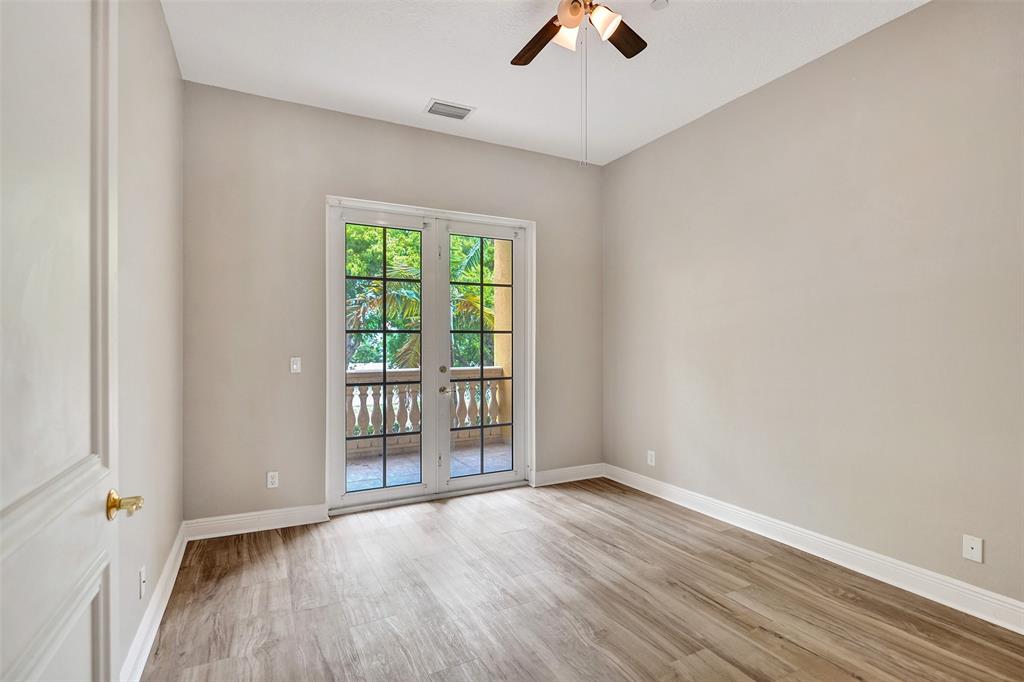 230 Northeast 69th Circle, Unit 230 Boca Raton, FL 33487 - Photo 59 of 91 wooden floor in an empty room with a window