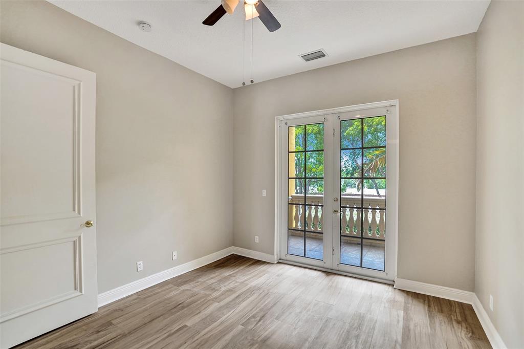 230 Northeast 69th Circle, Unit 230 Boca Raton, FL 33487 - Photo 60 of 91 a view of an empty room with wooden floor and a window