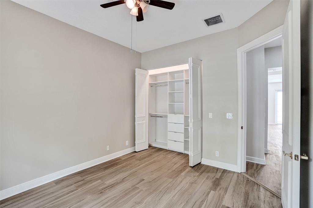 230 Northeast 69th Circle, Unit 230 Boca Raton, FL 33487 - Photo 61 of 91 an empty room with wooden floor cabinet and windows
