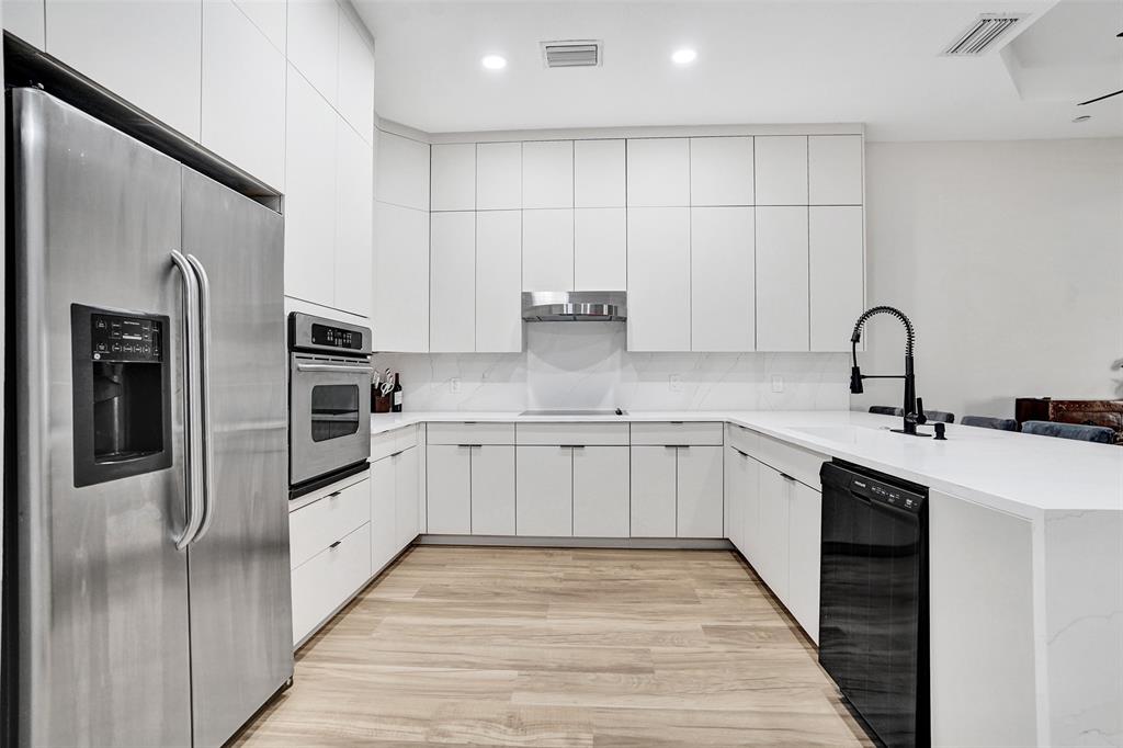 230 Northeast 69th Circle, Unit 230 Boca Raton, FL 33487 - Photo 7 of 91 a kitchen with stainless steel appliances granite countertop a refrigerator sink and white cabinets