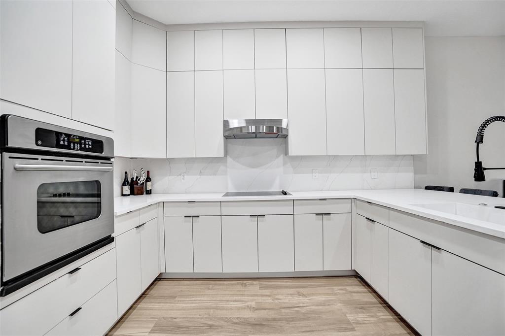 230 Northeast 69th Circle, Unit 230 Boca Raton, FL 33487 - Photo 8 of 91 a kitchen with granite countertop white cabinets and white appliances