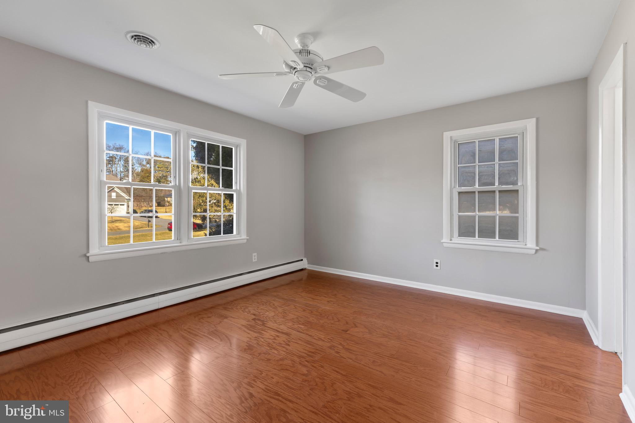 412 Vierling Drive Silver Spring, MD 20904 - Photo 18 of 35 an empty room with wooden floor and windows