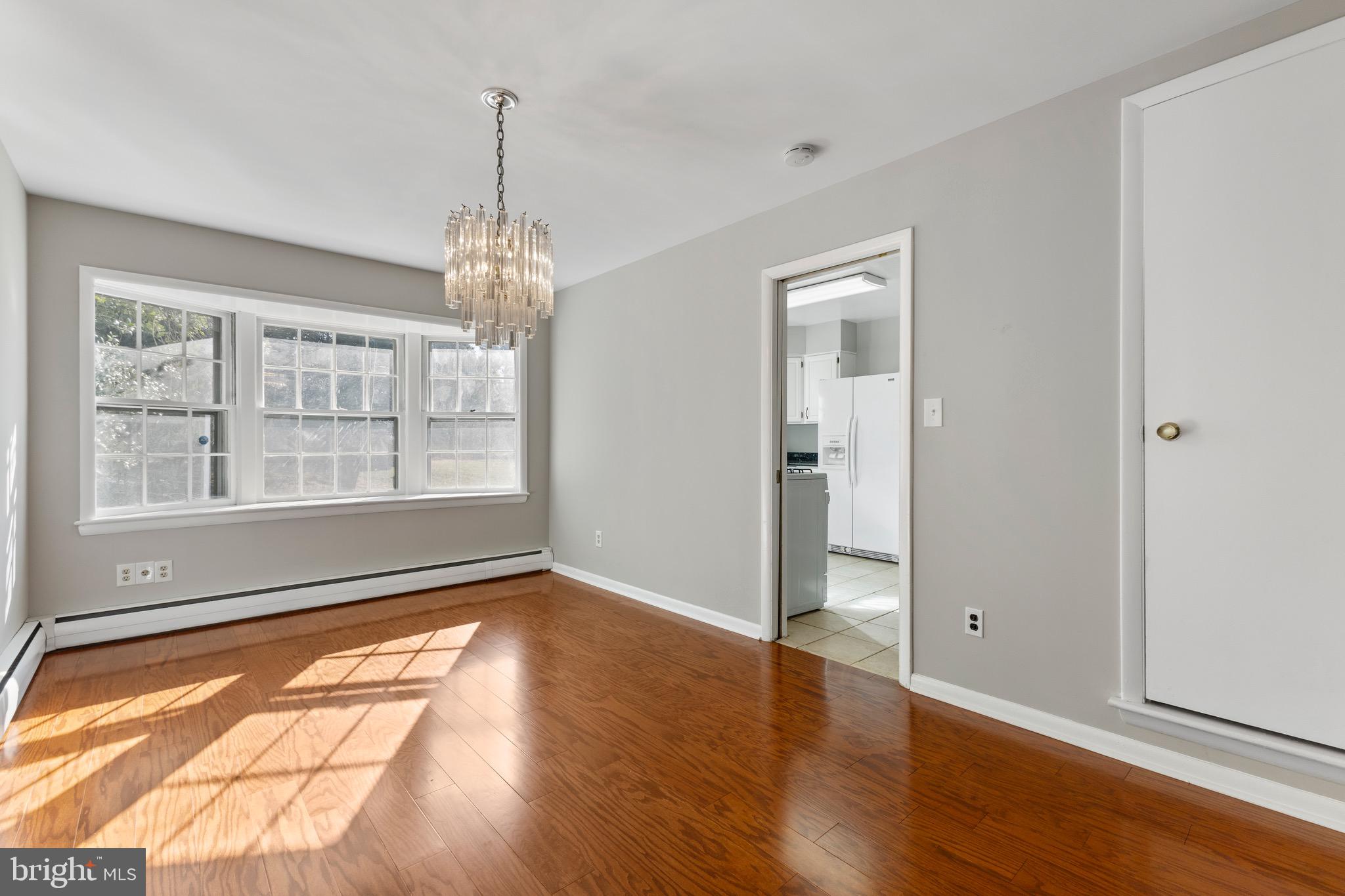 412 Vierling Drive Silver Spring, MD 20904 - Photo 22 of 35 an empty room with wooden floor and windows