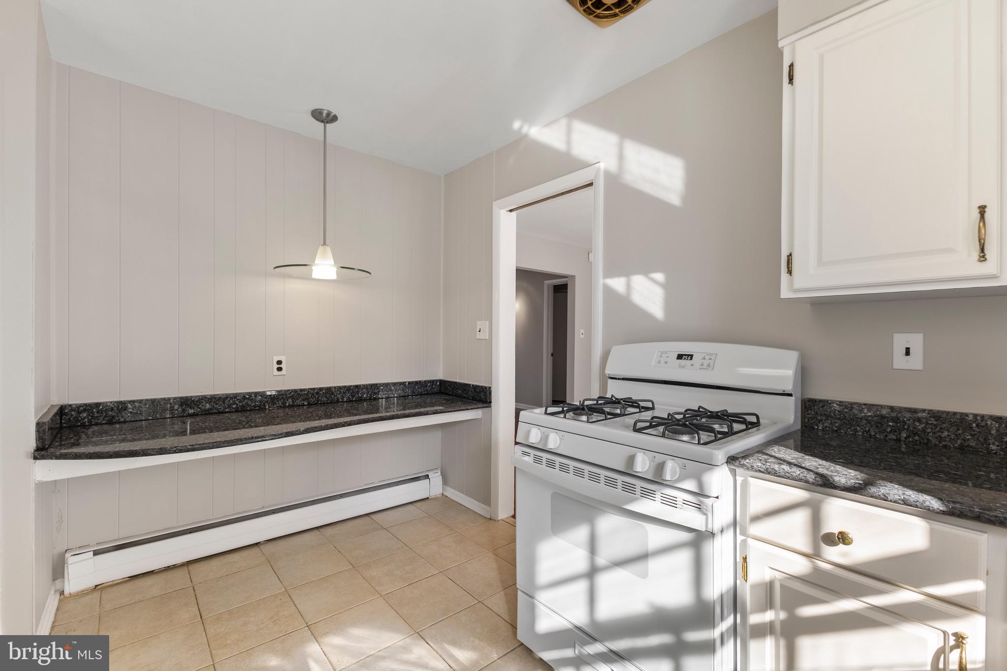 412 Vierling Drive Silver Spring, MD 20904 - Photo 25 of 35 a kitchen with granite countertop a stove a sink and a refrigerator
