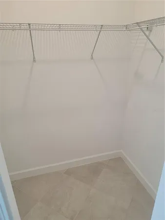 a bathroom with a granite countertop sink and white cabinets