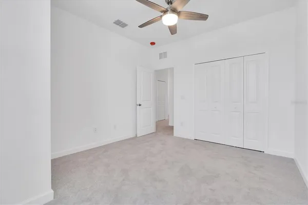 a view of a house with backyard and porch