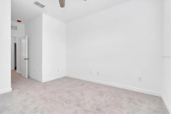 a view of a bedroom with a large bed and a chandelier