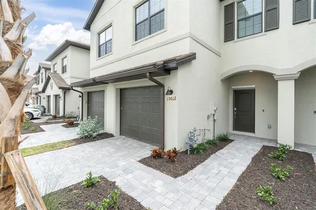 a front view of a house with garden
