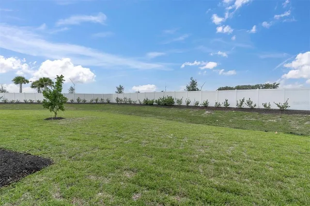 a view of a lake with houses in the back