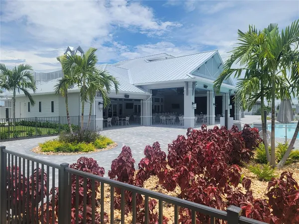 a dining room with stainless steel appliances kitchen island granite countertop a dining table chairs and view kitchen