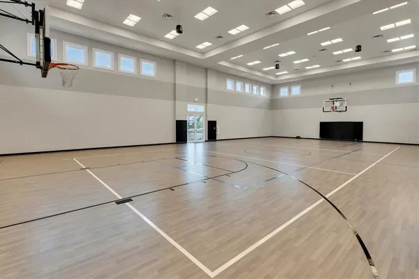 a living room with furniture a clock and a potted plant