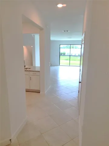 a kitchen with stainless steel appliances granite countertop a refrigerator sink and stove