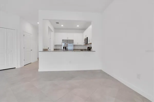 a view of a kitchen with a sink and a refrigerator