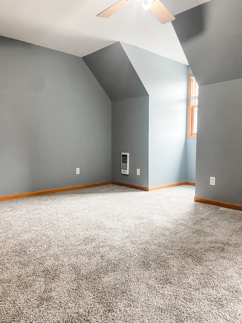 1308 Axcel Lane Sycamore, IL 60178 - Photo 19 of 40 a view of an empty room with a fireplace