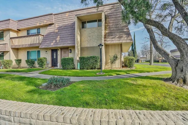a front view of a building with a garden