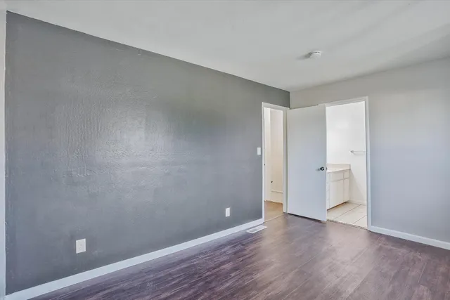 a view of an empty room and wooden floor